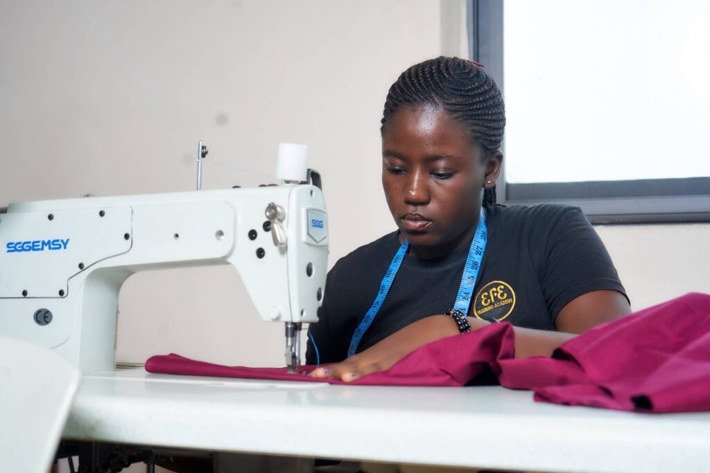 Student behind sweing machine